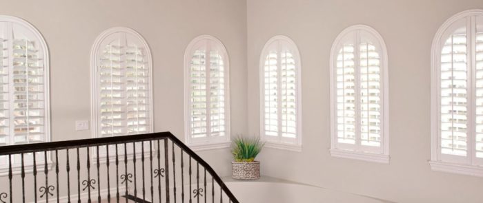 Plantation shutters on arched windows